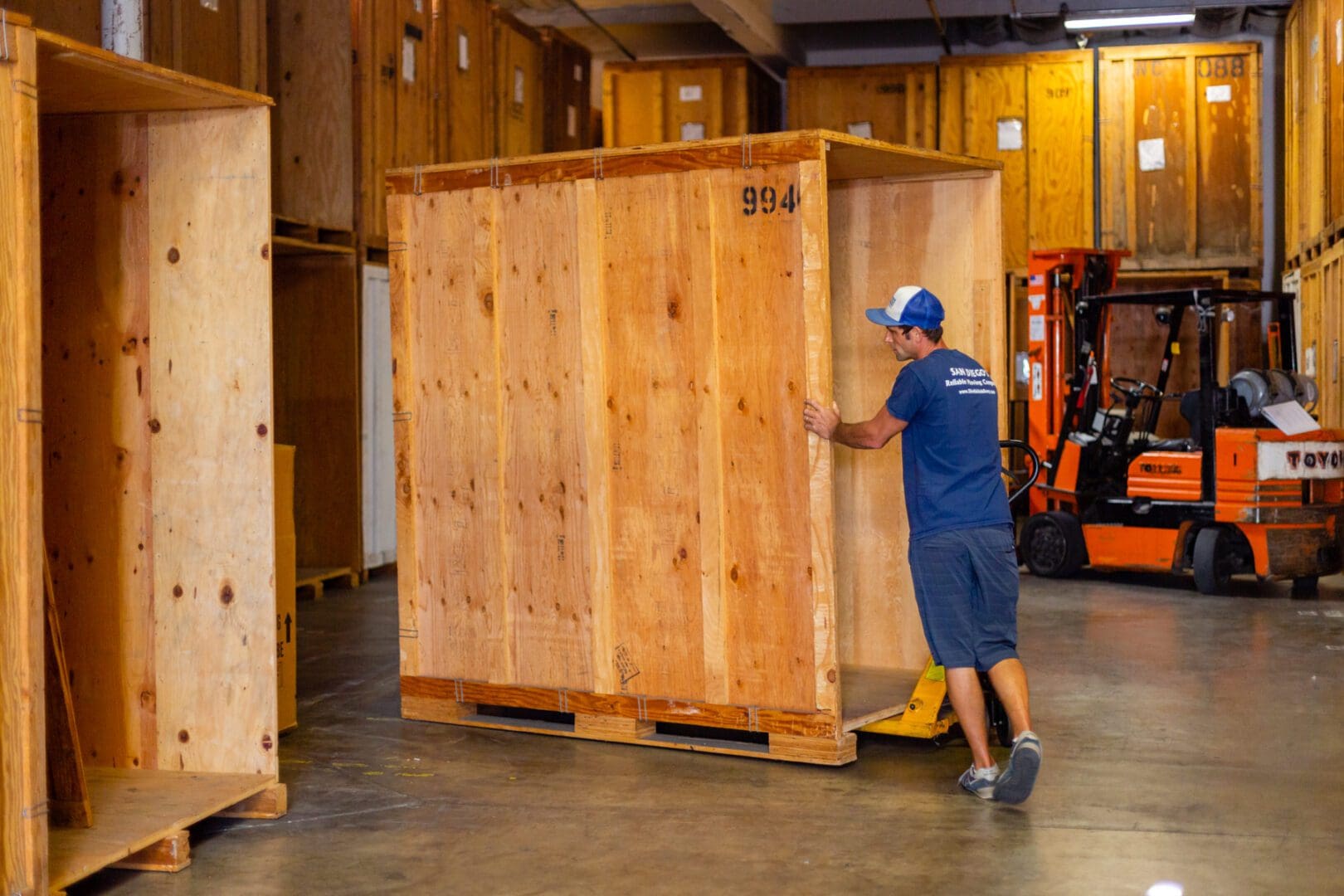 A man moving boxes in a warehouse.