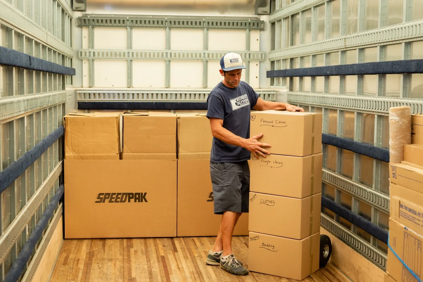 A man standing in front of boxes on the floor.