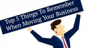 Businessman holding a sign with "top 5 things to remember when moving your business" written on it.